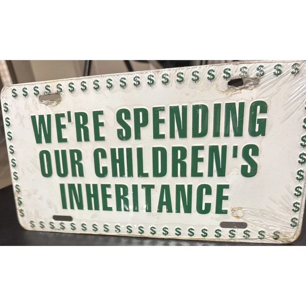 Vintage WE'RE SPENDING OUR CHILDREN'S INHERITANCE Booster License Plate